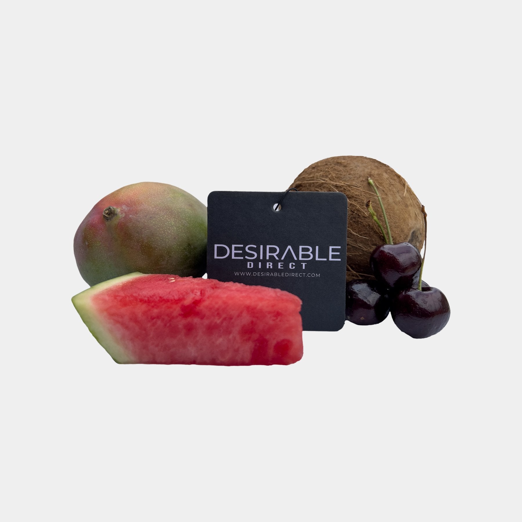 Car care black car air freshener with desirable direct and desirabledirect.com printed on the front, displayed on a white background surrounded by fruit to show the different scents available.