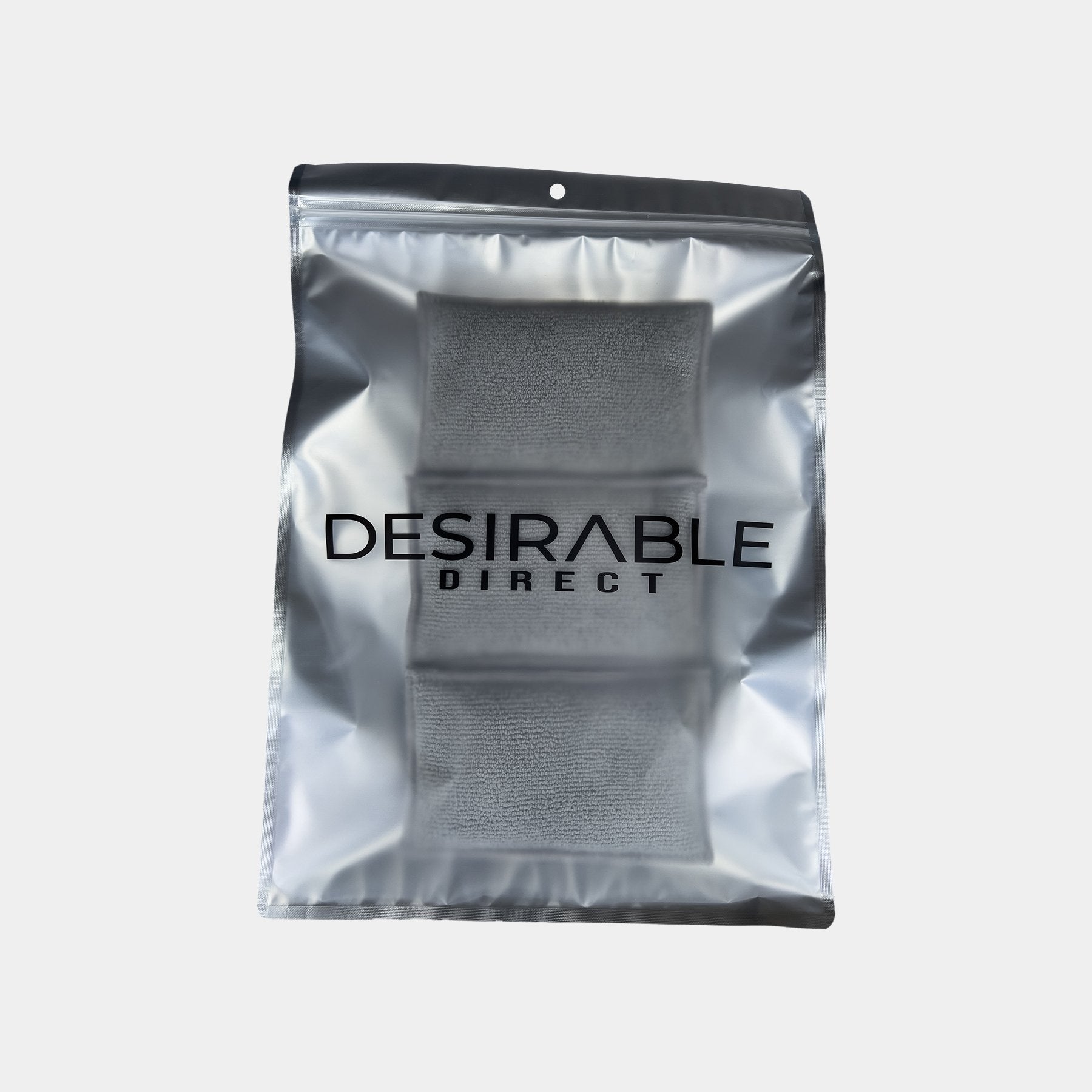 Car care three microfibre grey interior scrub pads are displayed on a white background in silver packaging with desirable direct printed on the front to keep the item clean when not in use.