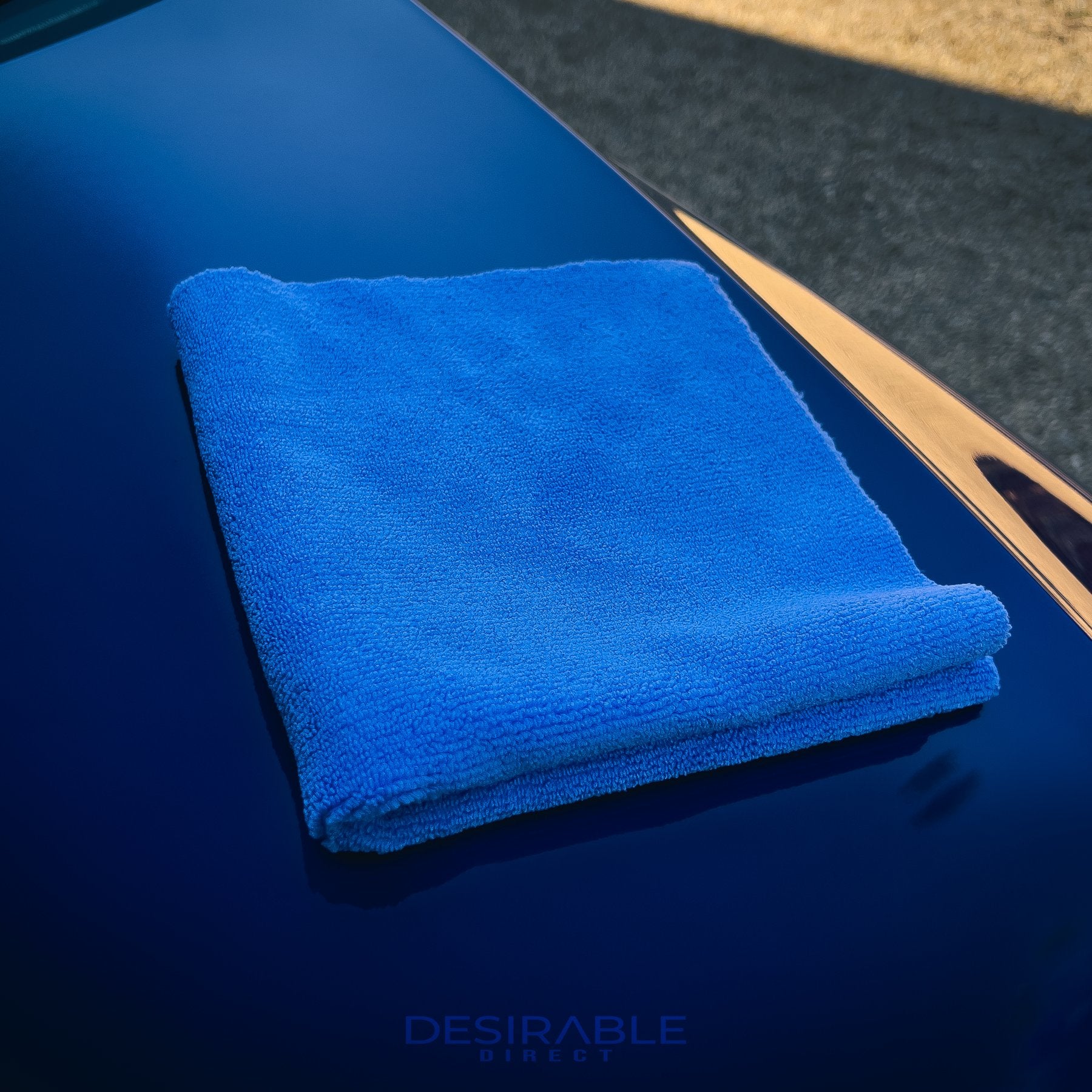 Car care microfibre soft blue multi-purpose cloth 40x40cm on the bonnet of a blue volkswagen golf r.