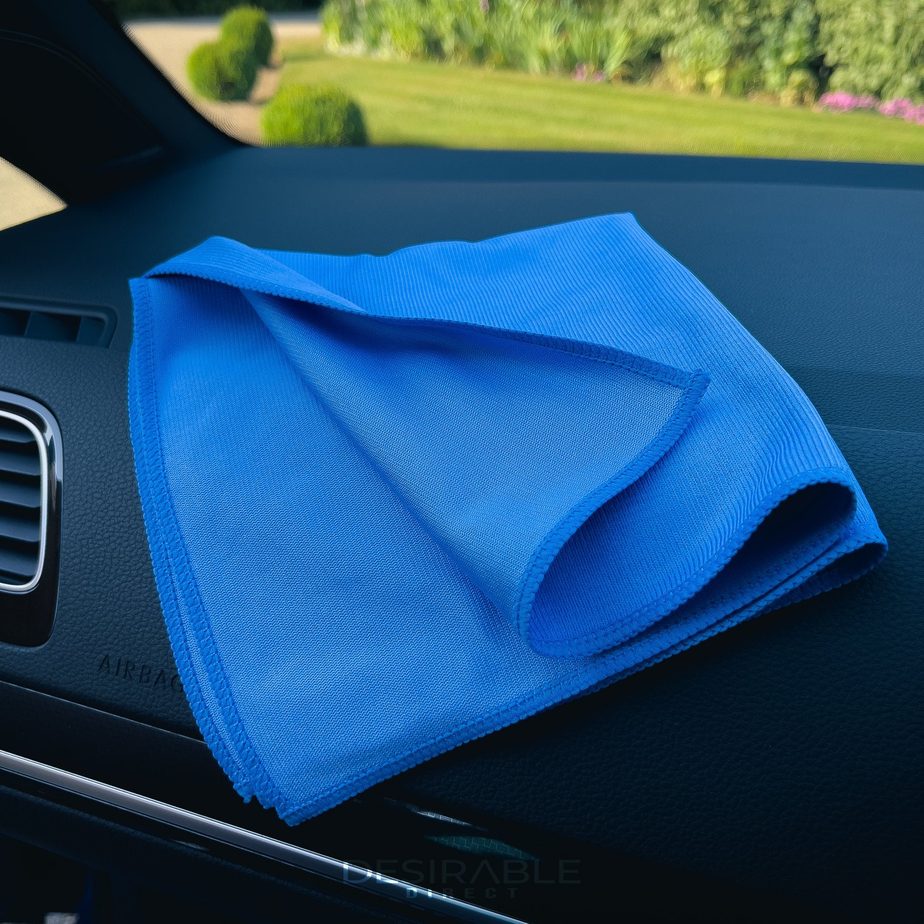 Car care microfibre blue glass cloth 40x40cm displayed on the dashboard of a blue volkswagen golf r.