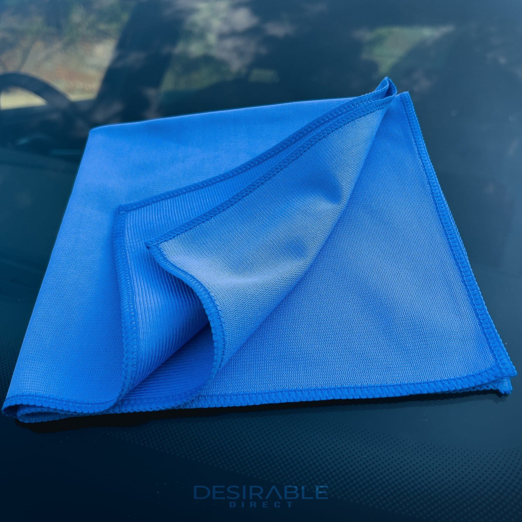 Car care microfibre blue glass cloth 40x40cm displayed on a car windscreen.