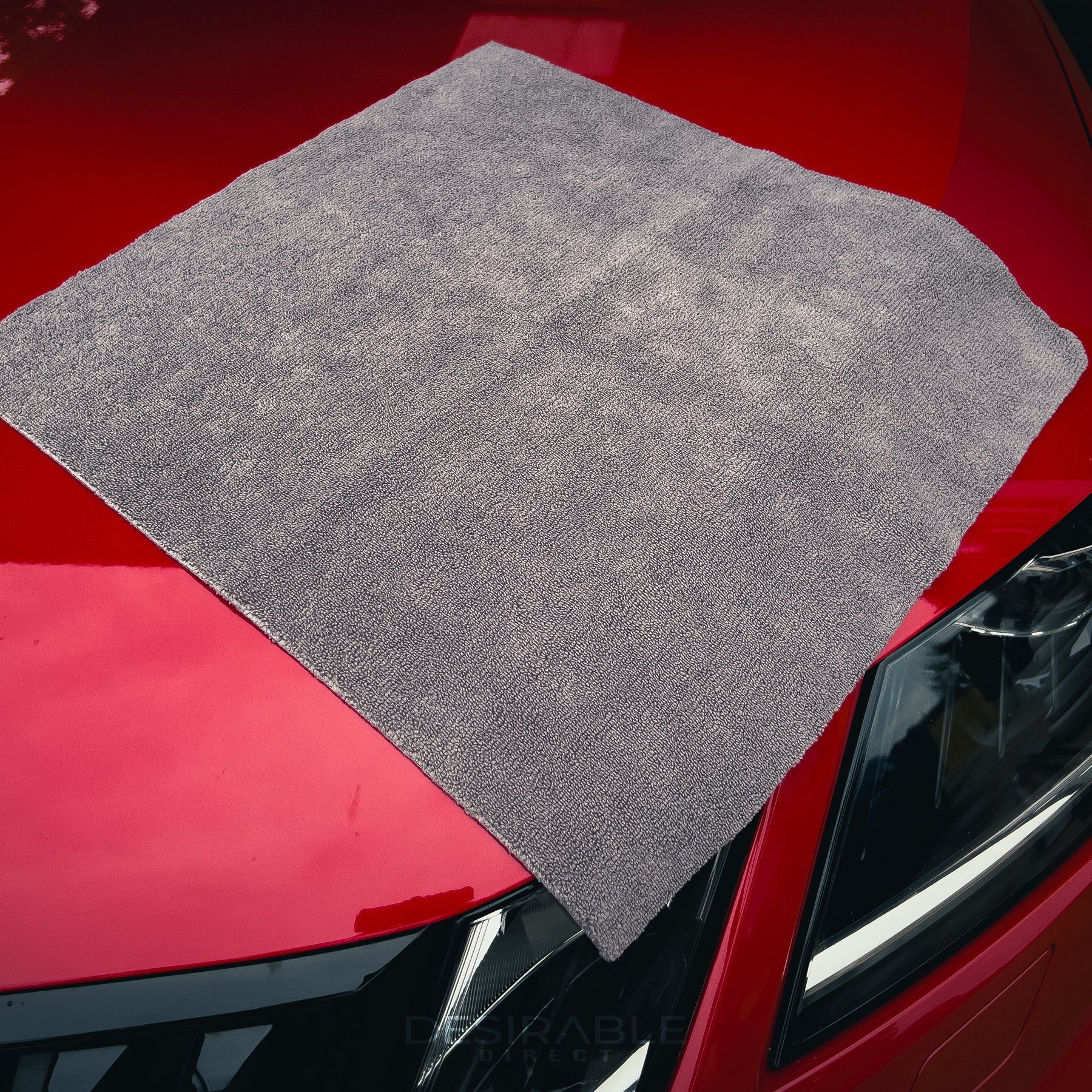 Car care microfibre grey cloth 40x40cm displayed on the bonnet of a red car.