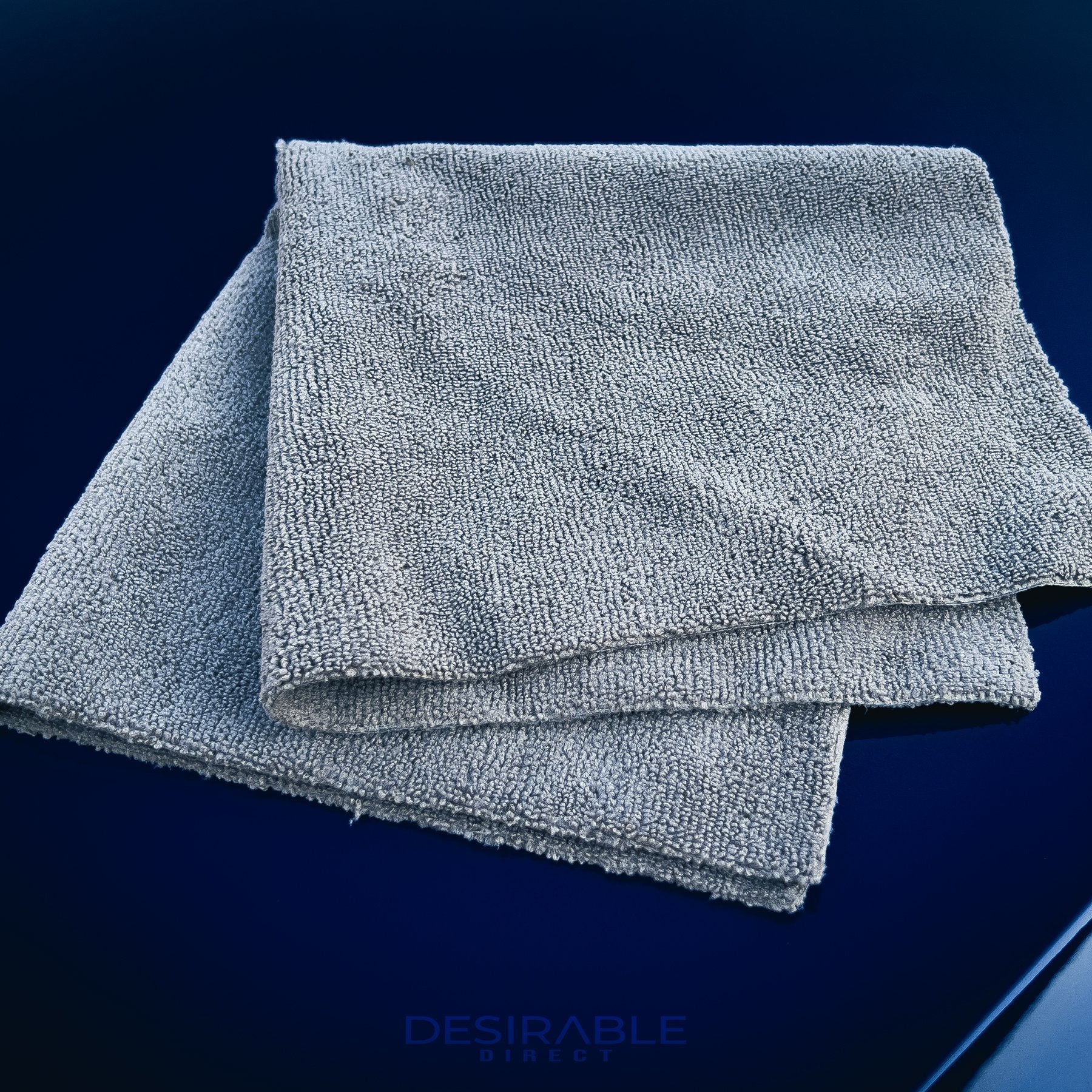 Car care microfibre grey cloth 40x40cm displayed on the bonnet of a blue volkswagen golf r.