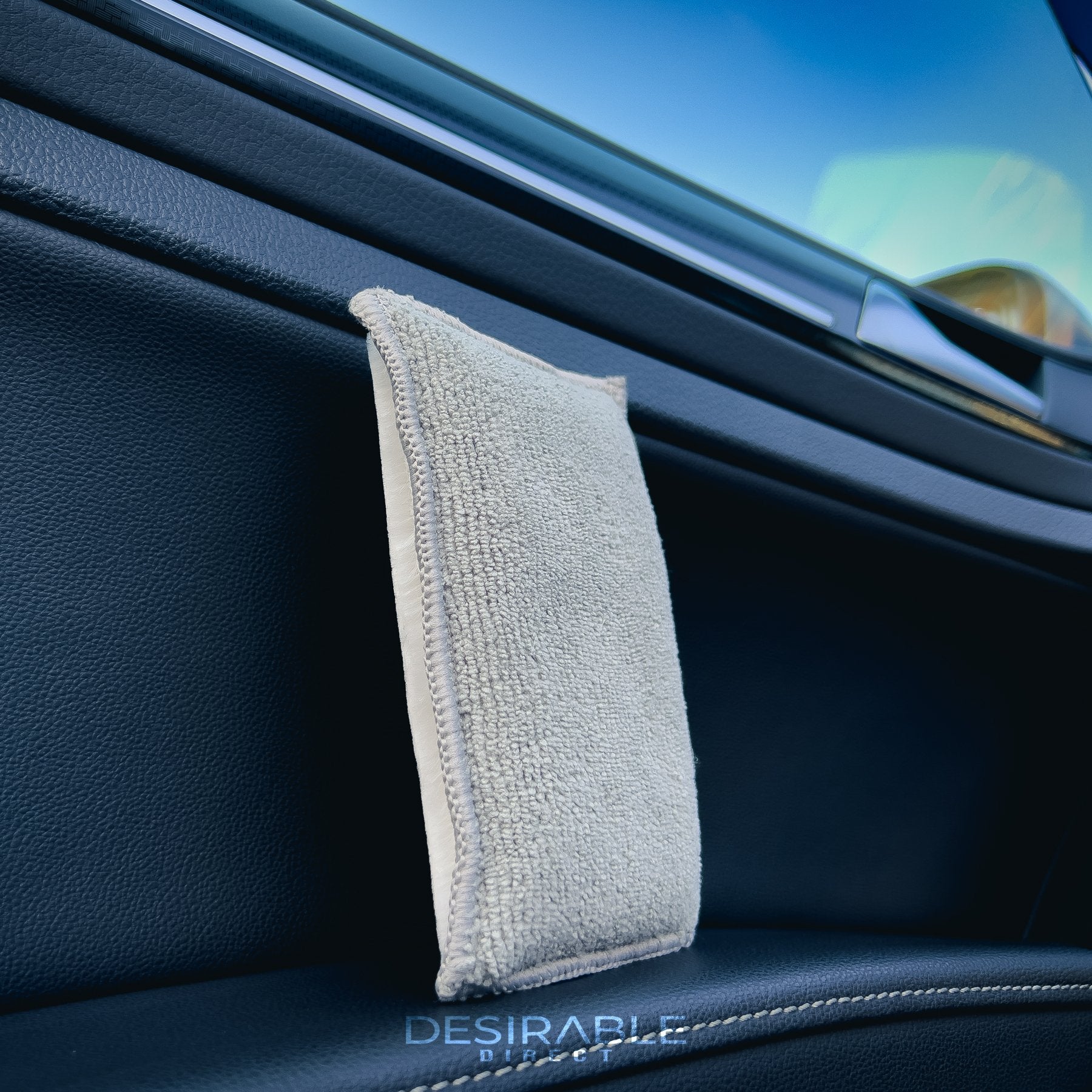 Car care one microfibre grey interior scrub pad standing on the arm rest of the passenger side door on a volkswagen golf r