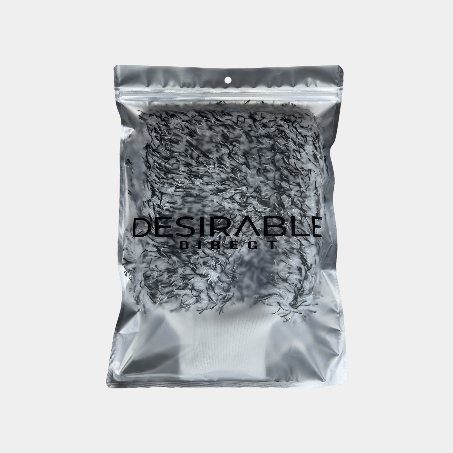 Car care microfibre black and white cleaning wash mitt displayed on a white background in silver packaging with desirable direct printed on the front to keep the item clean when not in use.