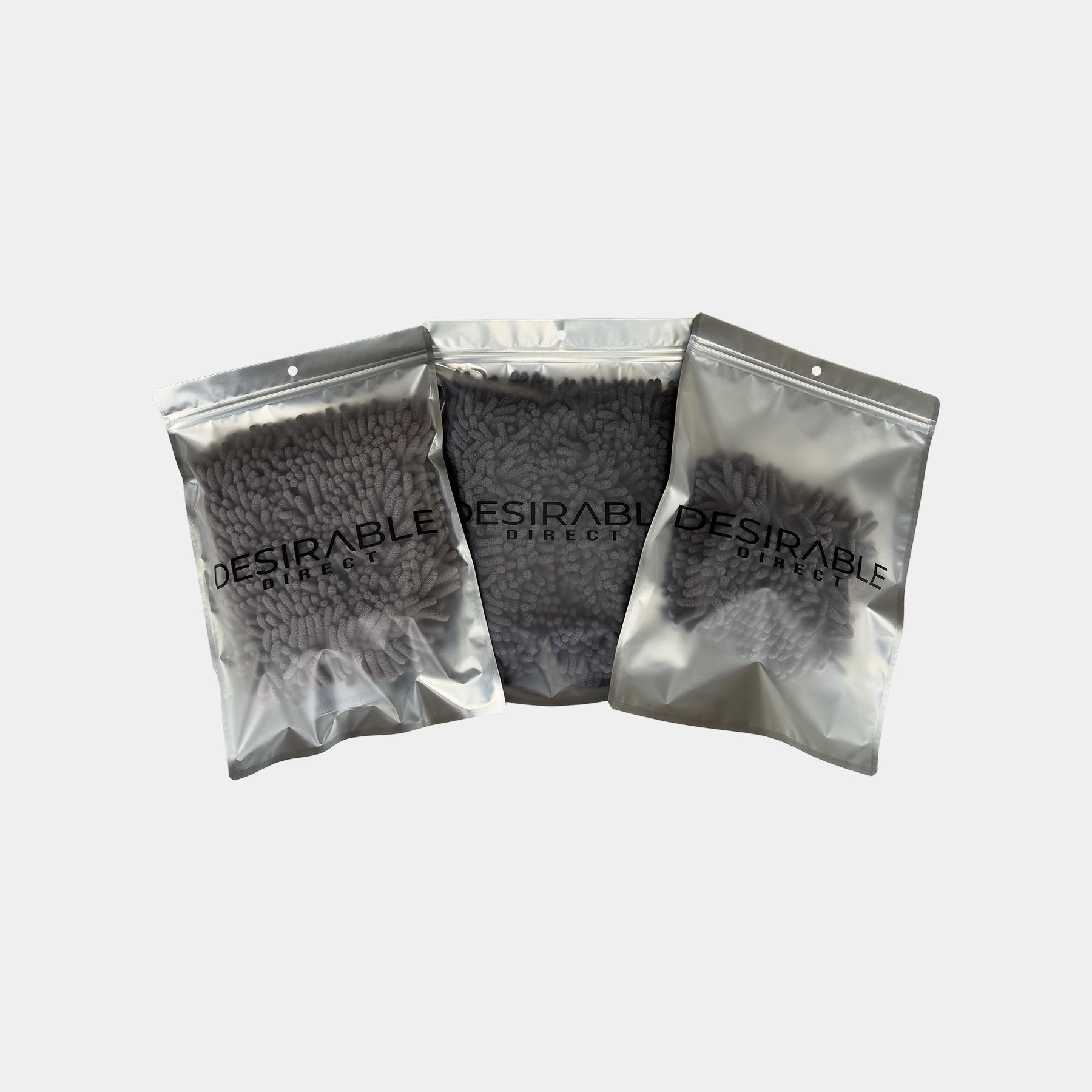 Car care noodle grey wash mitt and pad bundle displayed on a white background in silver packaging with desirable direct printed on the front to keep the item clean when not in use.