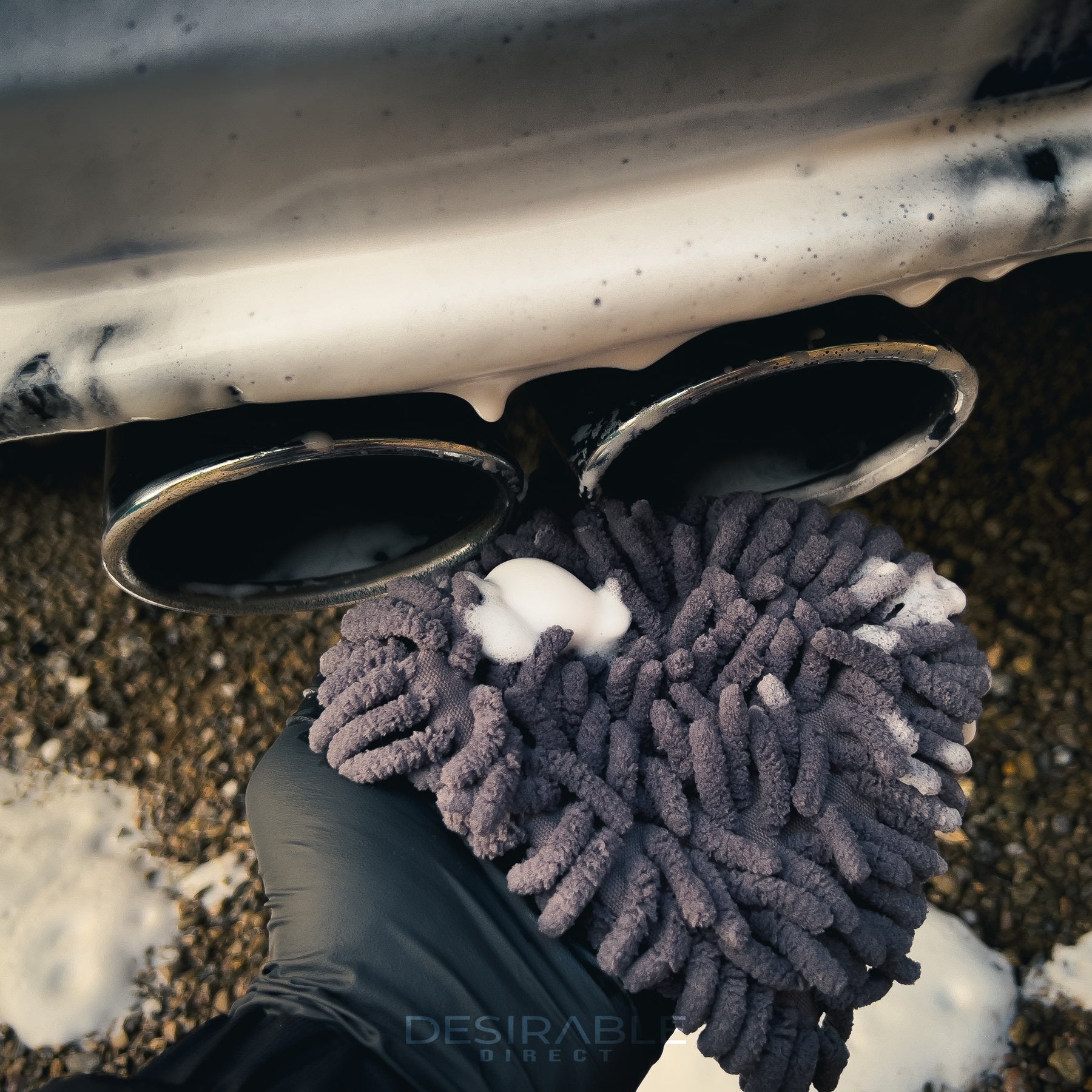 Car care chenille grey wheel and trim noodle wash pad cleaning the exhaust of a blue volkswagen golf r